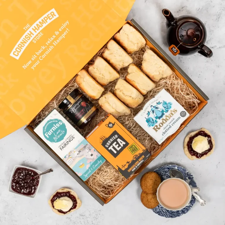 Cornish cream tea hamper beautifully laid out containing Rodda's Clotted Cream, scones, Cornish tea, jam and biscuits