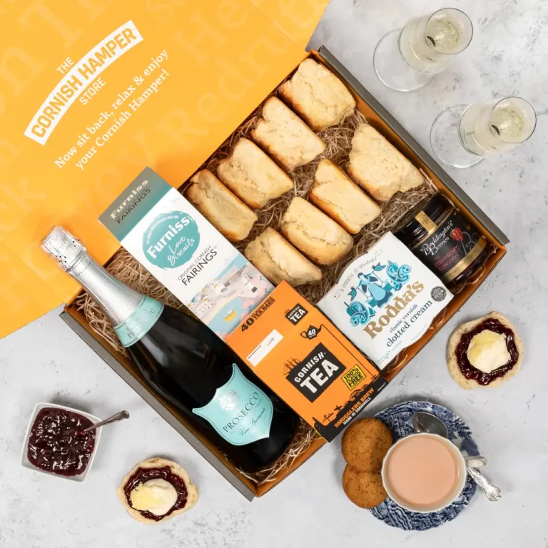 Cornish Cream Tea Gift Hamper with Vino Spumante Prosecco. The contents are presented on a bed of classic hamper straw