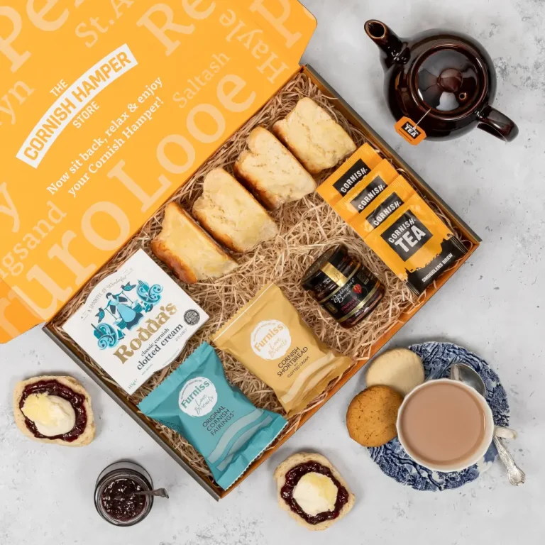 Cornish cream tea hamper beautifully laid out containing Rodda's Clotted Cream, scones, Cornish tea, jam and biscuits