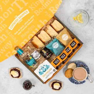 Cream tea hamper with Black Rock gin and Navas tonic. Cornish scones, biscuits, jam, tea and clotted cream nestle beside the gin and tonic on a bed of hamper straw