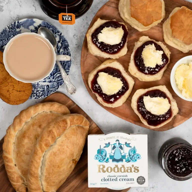 Two original Cornish pasties beside scones, jam and clotted cream