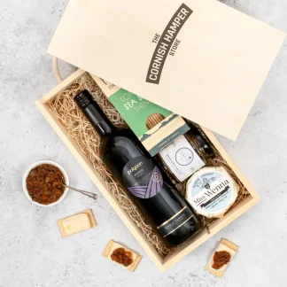 The Cheese Chutney and Wine Gift Set displayed in an opened wooden Cornish Hamper Store branded box