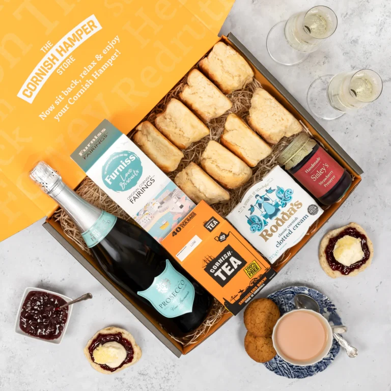 Cornish Cream Tea Gift Hamper with Vino Spumante Prosecco. The contents are presented on a bed of classic hamper straw