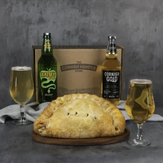 Giant Cornish Pasty surrounded by Rattler Original and Cornish Gold bottles of cider