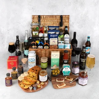 The Artisan Delights wicker picnic basket filled with the finest local Cornish produce. Includes Cornish beer, cider, ale and stout selection, cornish charcuterie items such as chutneys, crackers and olives and sweet treats such as fudge, caramel sauce and cornish cake