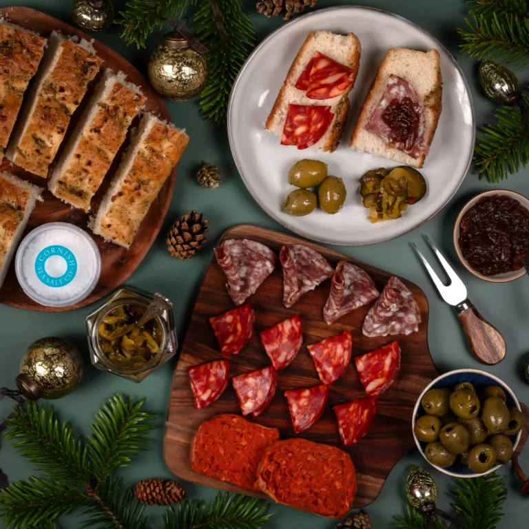 Christmas Charcuterie Hamper spread with a selection of Cornish meats, olives, garlic and rosemary bread and Cornish sea salt