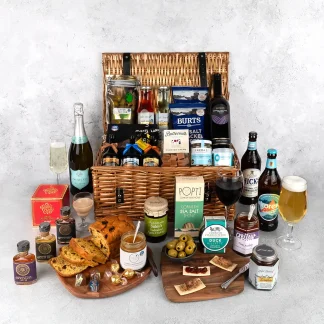 Wicker gift basket filled with local Cornish produce. Includes Cornish alcohol, charcuterie items and sweet treats