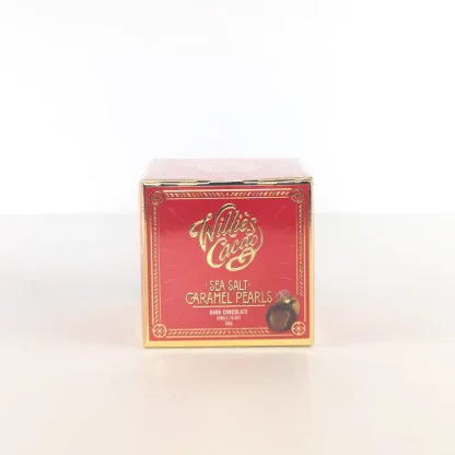 A singular red box of Willies sea salt caramel pearls with gold text and a gold border