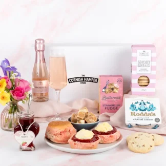 Mother’s Day cream tea hamper in pink and white. Pink scones, strawberry jam, prosecco rose, biscuits, fudge and cream