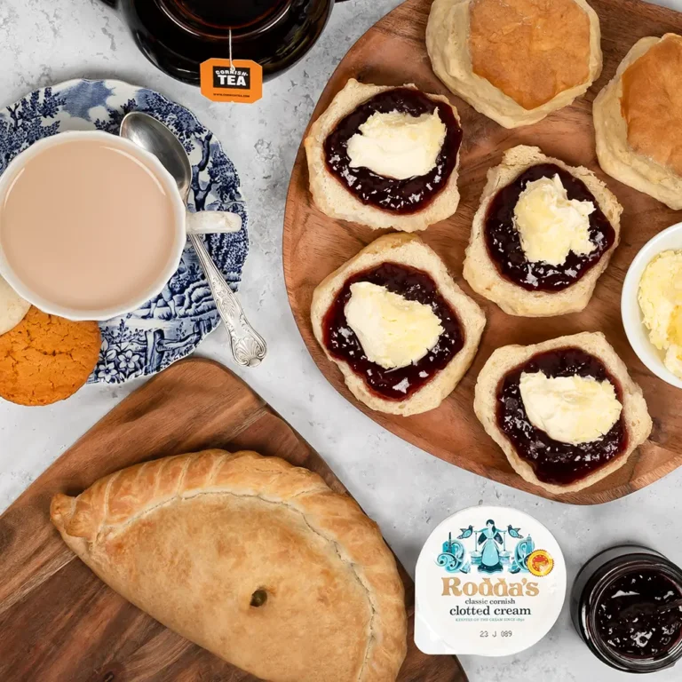 Gluten free cornish pasty beside plate of free from gluten scones with jam and cream